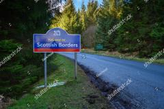 stock-photo-marker-sign-for-the-scottish-border-a-few-miles-north-west-of-kielder-in-northumberland-at-1670165332